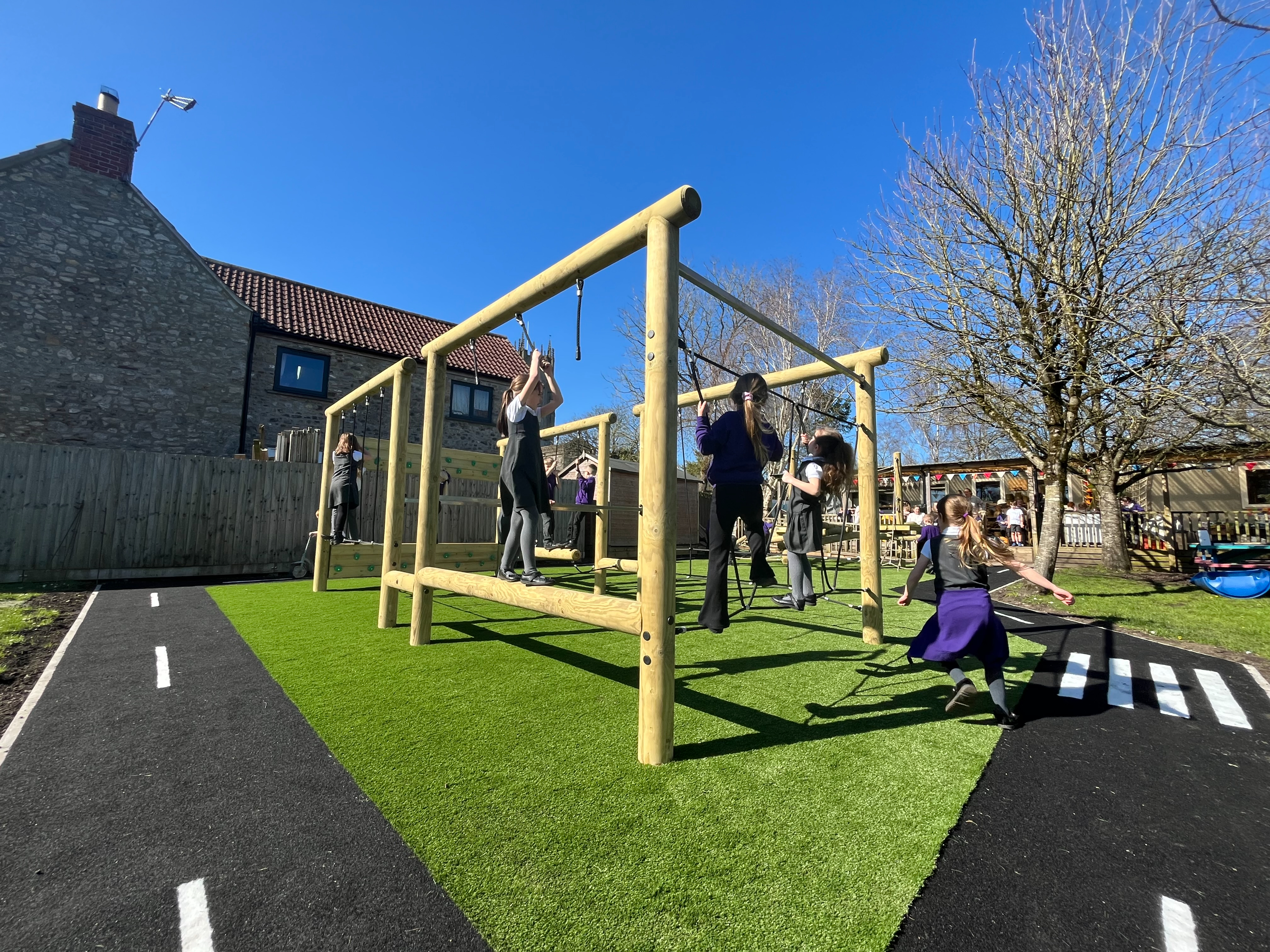 School Playground Development showing children playing on a Lemur Rig and surrounding roadway