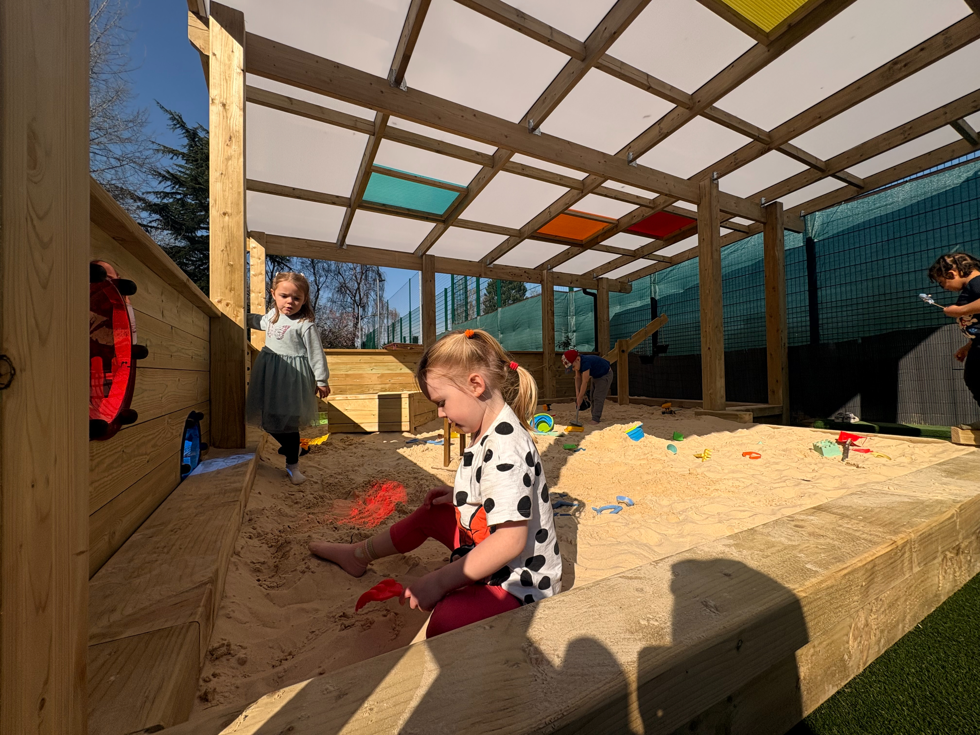 Canopy with Coloured Roof Panels covering Sand Play environment: Orton Longueville Playgroup