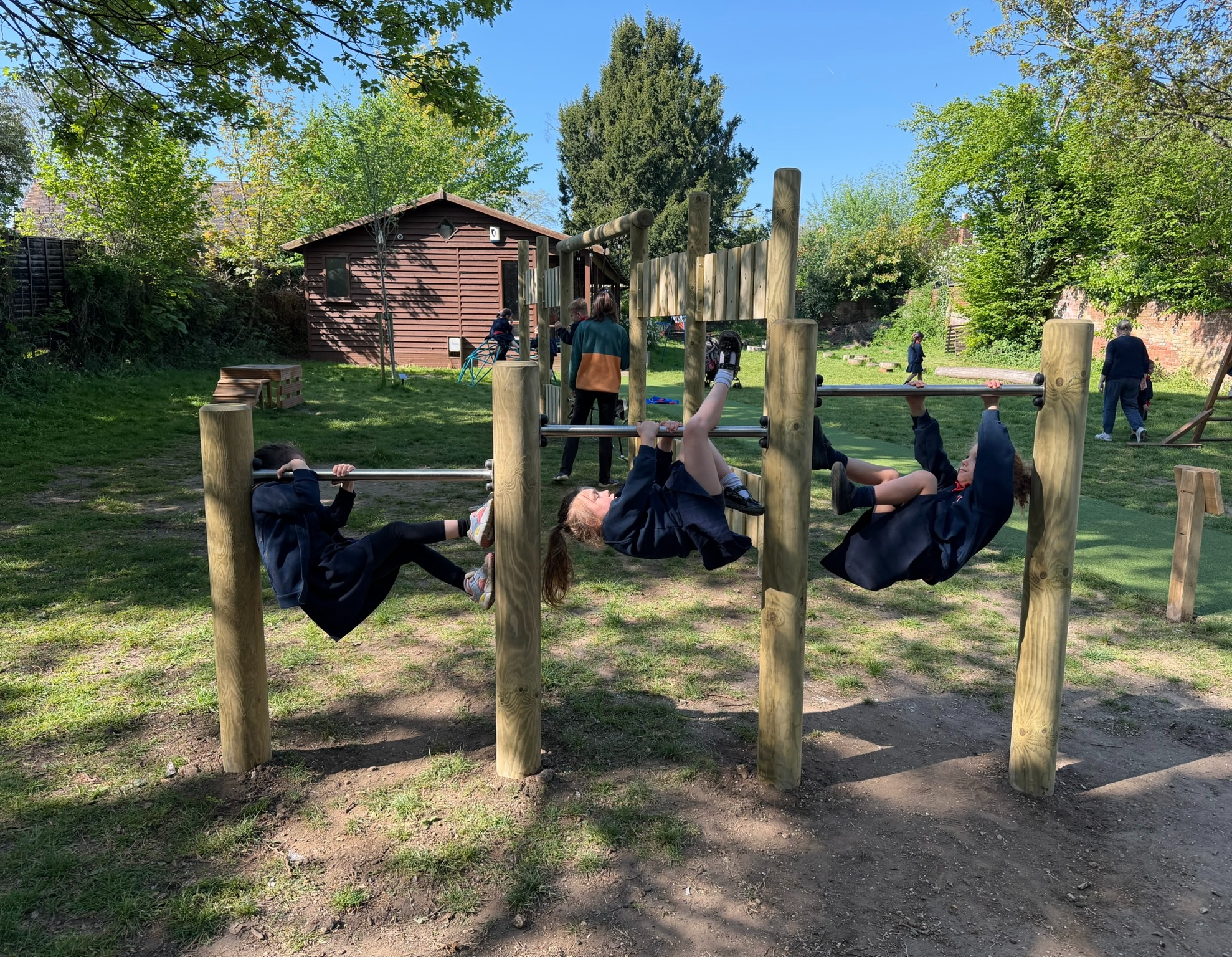 Sacred Heart Playground children playing on high bars